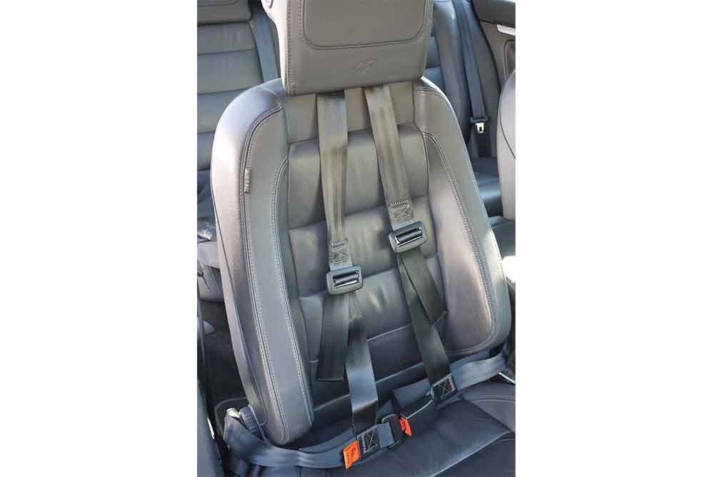Postural harness fitted to a car seat