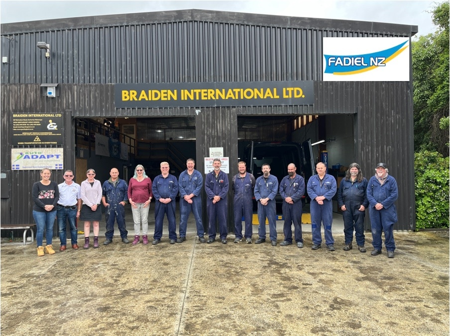 Braiden team lined up in front of workshop with Fadiel NZ logo on top right corner